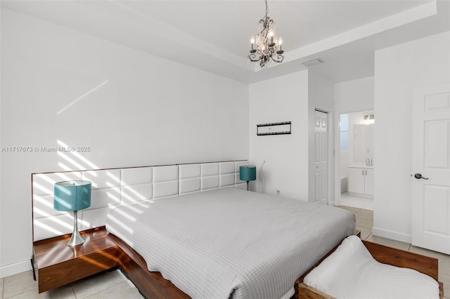 tiled bedroom with ensuite bathroom and a chandelier