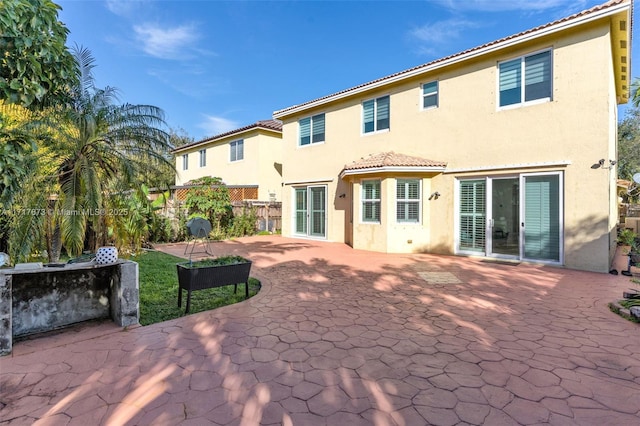 back of property featuring a patio area