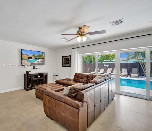 living room with light tile patterned floors, french doors, and ceiling fan