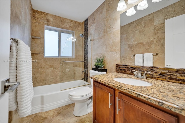 full bathroom featuring tiled shower / bath, tile walls, decorative backsplash, vanity, and toilet