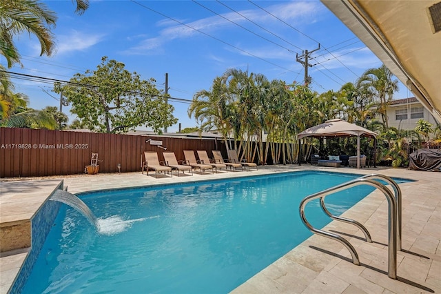 view of swimming pool with a gazebo, pool water feature, and a patio area