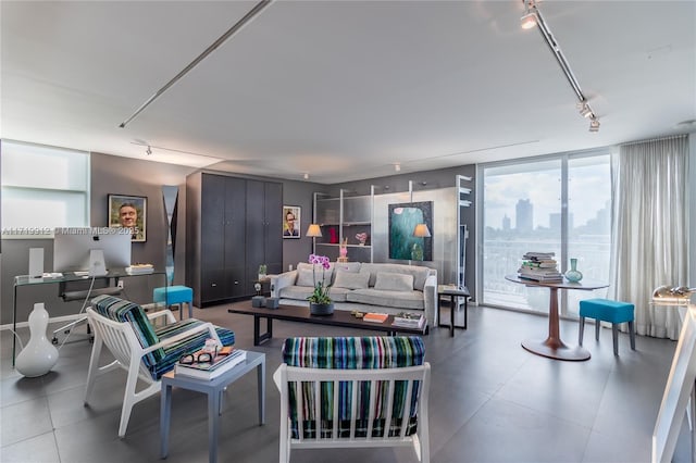 living room featuring track lighting and a wall of windows