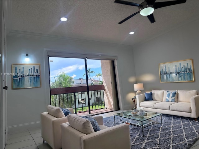 living room featuring ceiling fan, tile patterned flooring, a textured ceiling, and ornamental molding