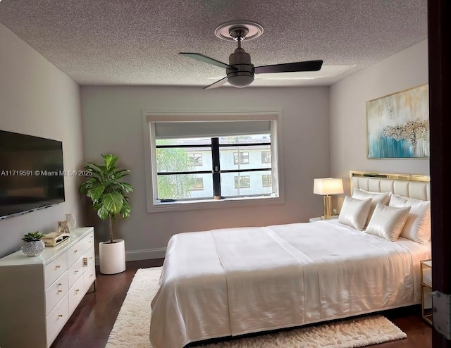 bedroom featuring a textured ceiling, ceiling fan, and dark wood-type flooring