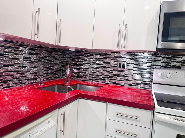 kitchen featuring white cabinets, decorative backsplash, range, and sink