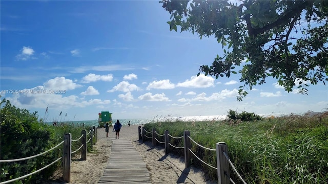 view of property's community featuring a view of the beach and a water view