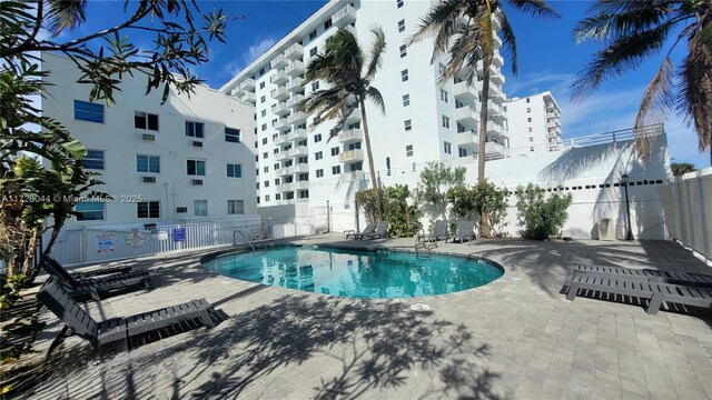 pool with fence and a patio area