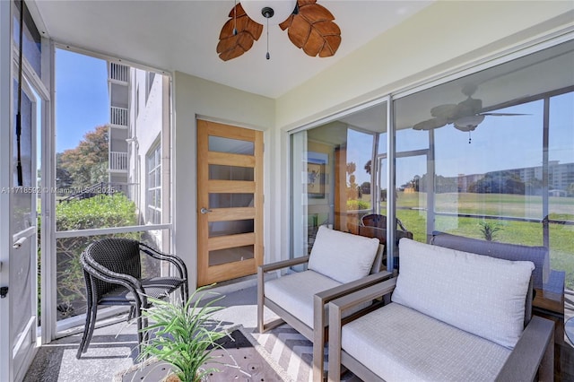 sunroom featuring ceiling fan