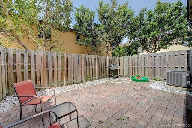 view of patio / terrace featuring area for grilling and cooling unit