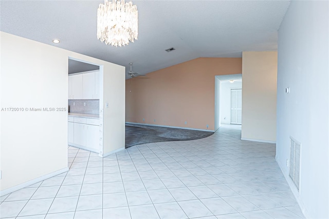 unfurnished room featuring ceiling fan with notable chandelier and vaulted ceiling