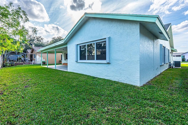 back of house with cooling unit, a yard, and a patio