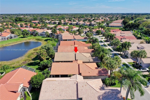 birds eye view of property with a water view and a residential view