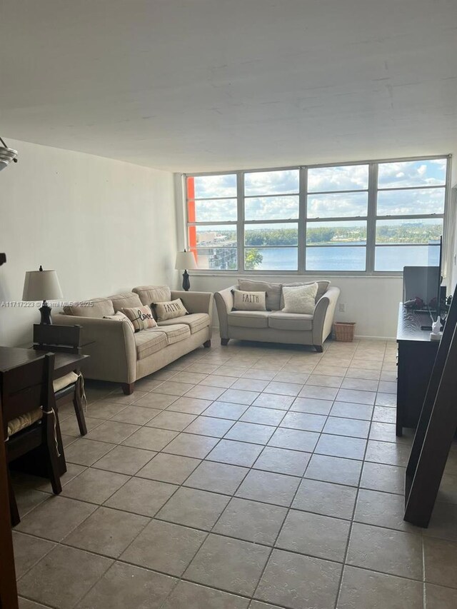 1301 NE Miami Gardens Dr Unit 1024W, Miami, FL 33179 - living area with light tile patterned floors and a water view
