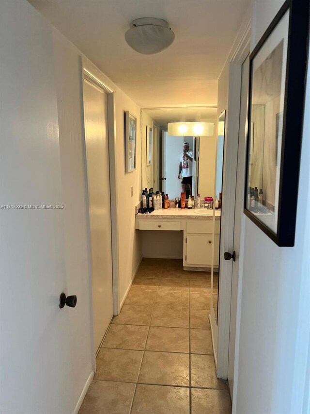 1301 NE Miami Gardens Dr Unit 1024W, Miami, FL 33179 - corridor featuring an office area, light tile patterned floors, a sink, and baseboards
