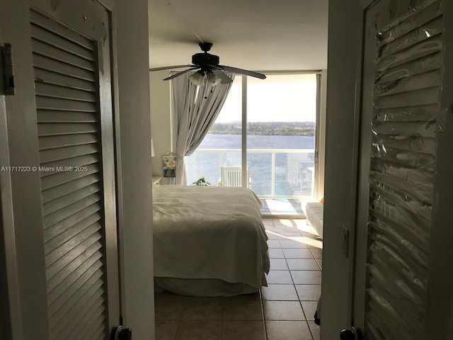 1301 NE Miami Gardens Dr Unit 1024W, Miami, FL 33179 - bedroom with tile patterned flooring, a water view, access to outside, floor to ceiling windows, and a ceiling fan