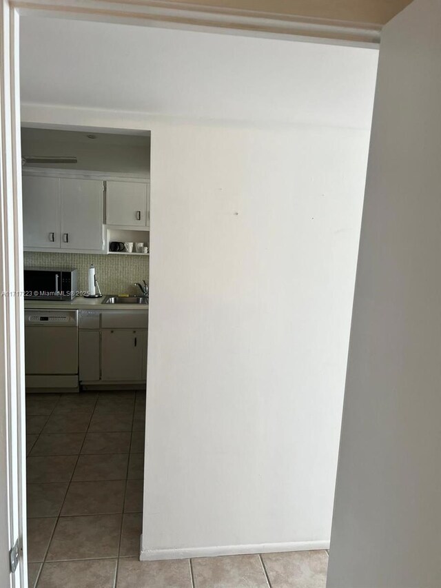 1301 NE Miami Gardens Dr Unit 1024W, Miami, FL 33179 - hallway featuring light tile patterned floors, a sink, and baseboards