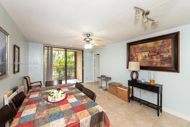 dining room with ceiling fan, light tile patterned floors, and a textured ceiling