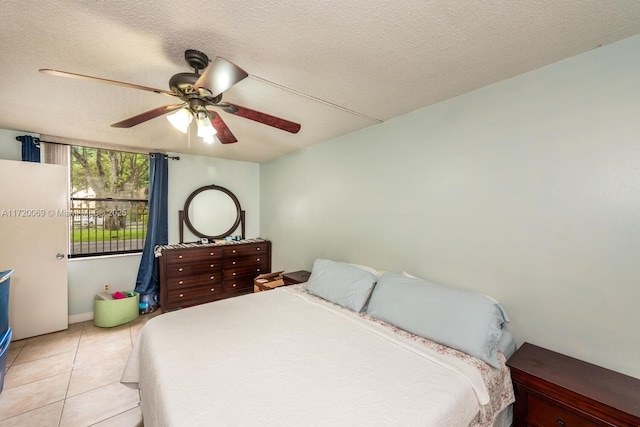 tiled bedroom with a textured ceiling and ceiling fan