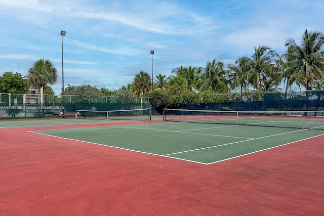 view of tennis court featuring basketball hoop