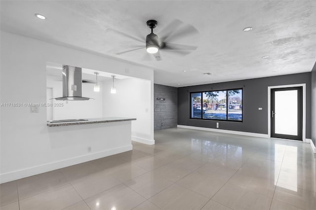 unfurnished living room with ceiling fan and light tile patterned floors