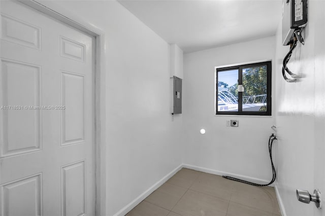 washroom with electric panel, light tile patterned flooring, and hookup for an electric dryer