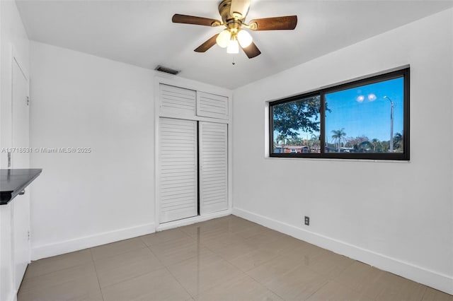 unfurnished bedroom with a closet and ceiling fan