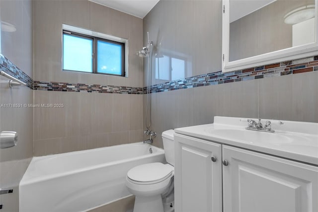 full bathroom with vanity, tiled shower / bath combo, tile walls, and toilet