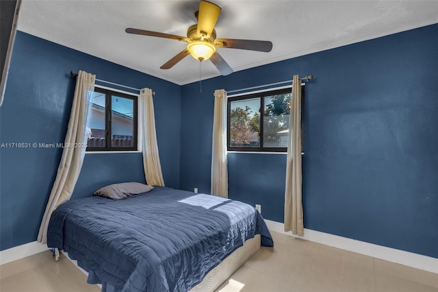 bedroom with multiple windows and ceiling fan