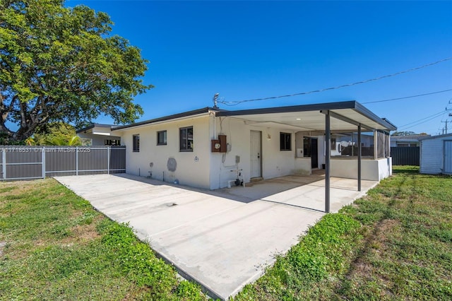 back of property featuring a sunroom and a yard