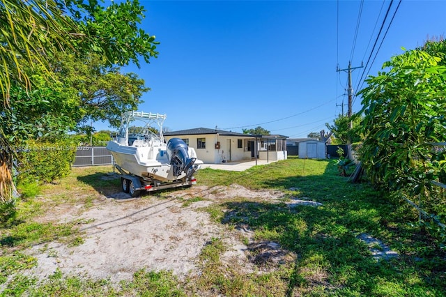 view of yard with a patio and a storage unit