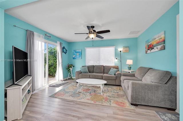 living room featuring light hardwood / wood-style flooring and ceiling fan