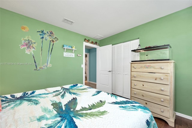 bedroom featuring dark hardwood / wood-style flooring and a closet