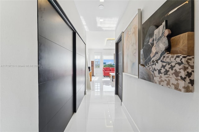 hall featuring light tile patterned flooring