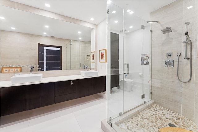 bathroom with tile patterned floors, vanity, a shower with shower door, and toilet