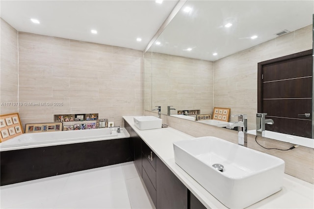 bathroom featuring tile patterned flooring, vanity, and tile walls