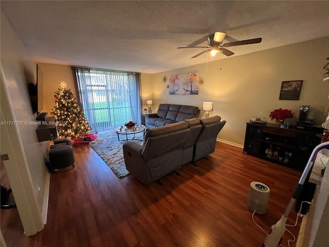 living room featuring a textured ceiling, dark hardwood / wood-style floors, expansive windows, and ceiling fan