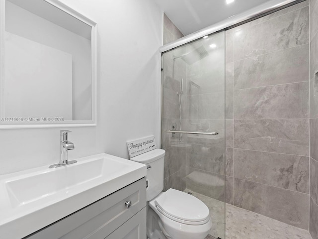 bathroom featuring walk in shower, vanity, and toilet