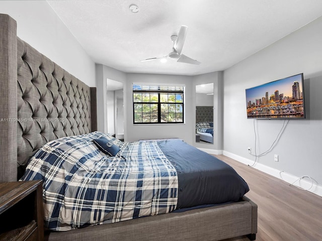 bedroom with ceiling fan and wood-type flooring