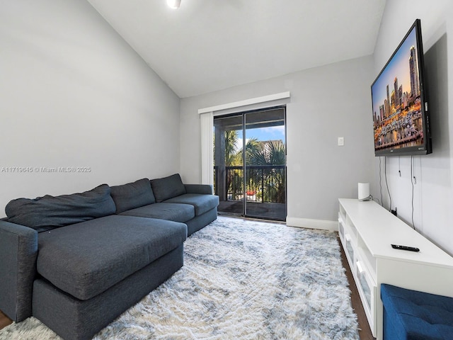 living room with wood-type flooring and lofted ceiling