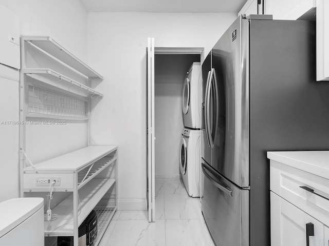 washroom featuring stacked washer / dryer