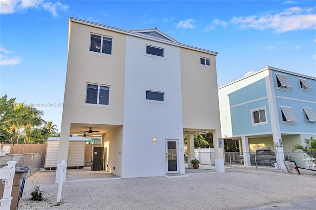 rear view of house featuring ceiling fan