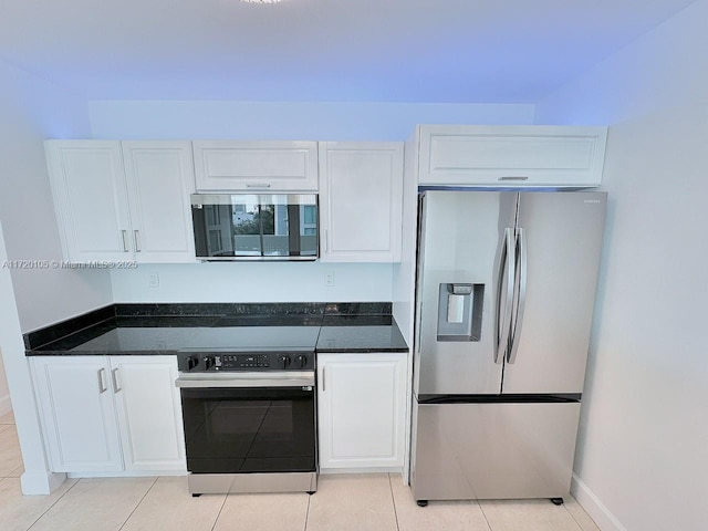 kitchen featuring white cabinets, light tile patterned floors, and appliances with stainless steel finishes