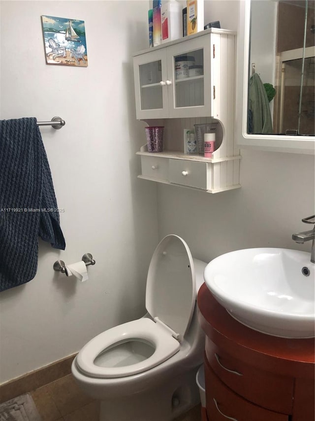 bathroom with tile patterned floors, vanity, and toilet