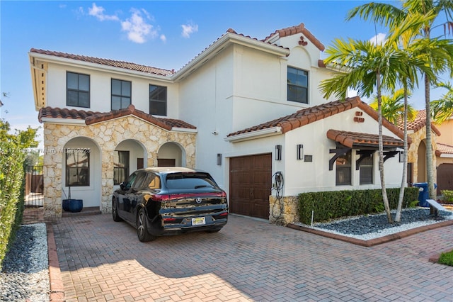 mediterranean / spanish house featuring a garage