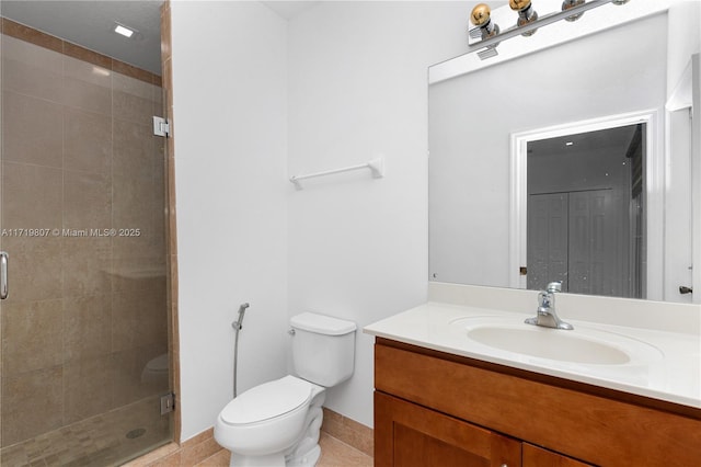 bathroom with tile patterned flooring, vanity, toilet, and a shower with shower door