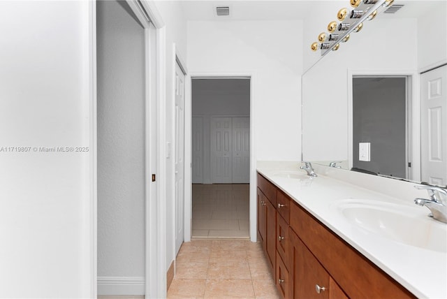 bathroom featuring tile patterned flooring and vanity