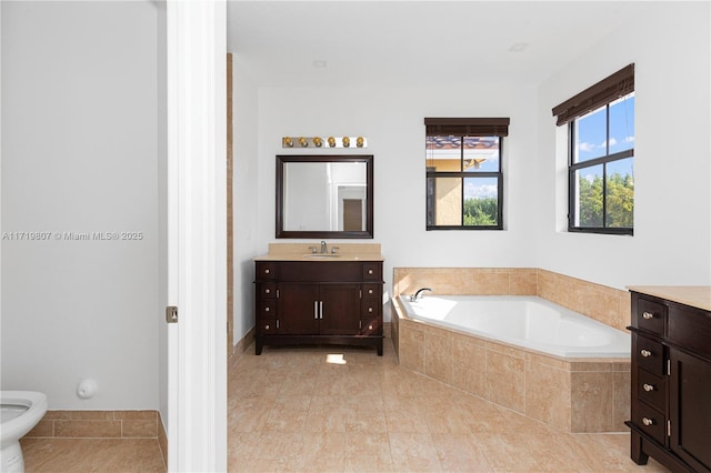 bathroom featuring tile patterned flooring, vanity, tiled bath, and a bidet