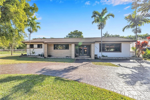 ranch-style home with a front lawn