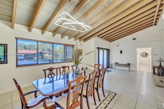 tiled dining area featuring beamed ceiling, high vaulted ceiling, and an inviting chandelier