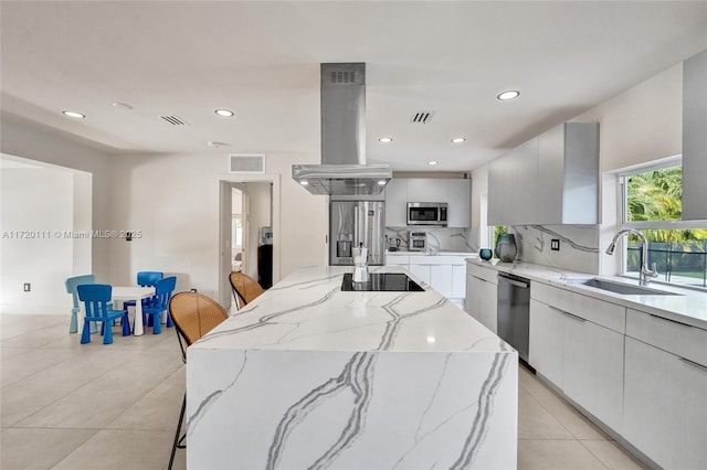 kitchen with sink, a kitchen breakfast bar, appliances with stainless steel finishes, and island exhaust hood